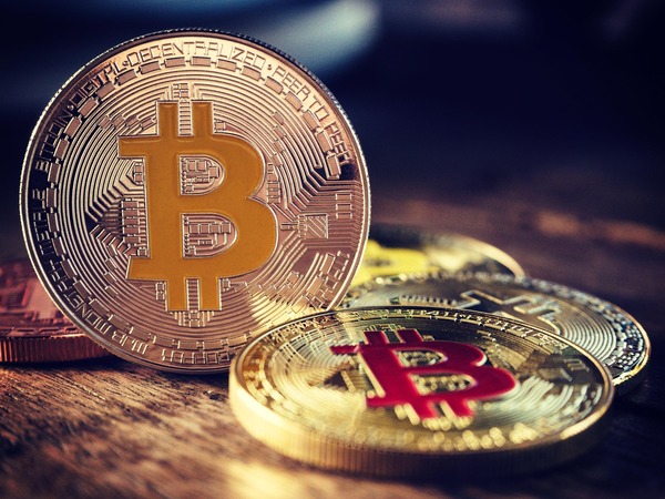 Small pile of cryptocurrency coins representing minimum transfer amounts